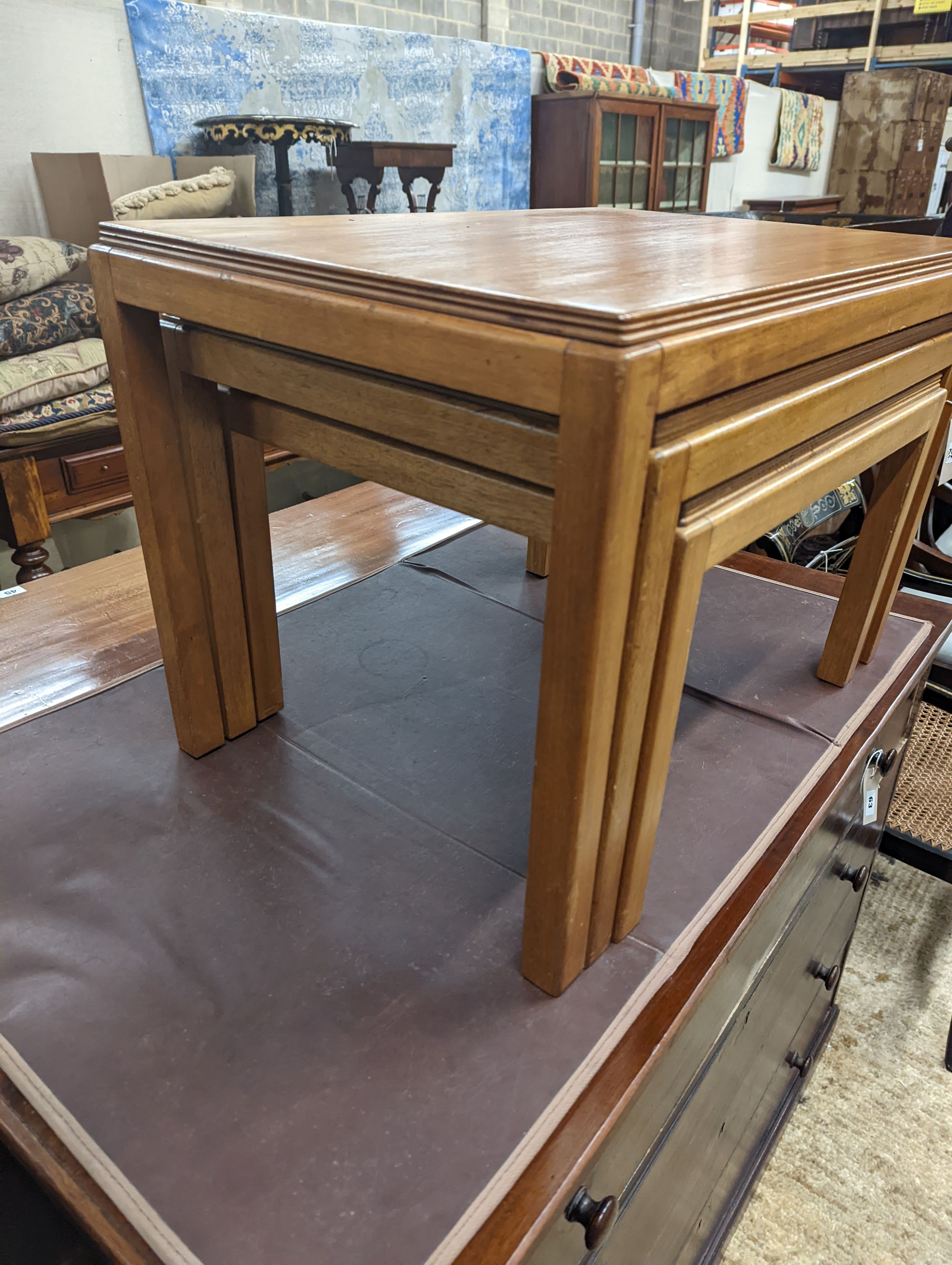 A nest of three Gordon Russell 1960's rectangular teak tea tables, width 68cm, depth 45cm, height 46cm
